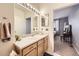 Bathroom featuring a large mirror and neutral color palette at 8976 Fox Dr # 101, Thornton, CO 80260