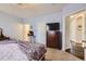 Cozy bedroom featuring soft carpet, a charming chandelier, and stylish decor at 8976 Fox Dr # 101, Thornton, CO 80260