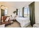 Bedroom filled with natural light showcasing a comfortable chair and leafy green plants at 8976 Fox Dr # 101, Thornton, CO 80260
