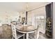 Elegant dining area with hardwood floors, modern lighting, and ample natural light at 8976 Fox Dr # 101, Thornton, CO 80260