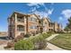 Stunning multi-Gathering building features private balconies, brick facade, and mature landscaping at 8976 Fox Dr # 101, Thornton, CO 80260