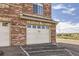 Detail of a single car garage for a multi-Gathering home constructed of red brick at 8976 Fox Dr # 101, Thornton, CO 80260