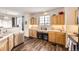 Well-lit kitchen includes wooden cabinets, white countertops, and dual wine coolers at 8976 Fox Dr # 101, Thornton, CO 80260