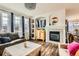 Cozy living room with a fireplace, hardwood floors, and bright natural light at 8976 Fox Dr # 101, Thornton, CO 80260
