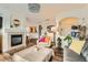 Living room featuring a fireplace, hardwood floors, and arched design elements at 8976 Fox Dr # 101, Thornton, CO 80260