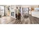 Open-concept living room featuring hardwood floors, fireplace, and dining area at 8976 Fox Dr # 101, Thornton, CO 80260