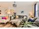 Living room with modern sofas, hardwood floors, and arched entryways at 8976 Fox Dr # 101, Thornton, CO 80260