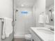 Sleek bathroom featuring a glass shower, modern fixtures, and a pristine white color scheme at 7856 W 43Rd Pl, Wheat Ridge, CO 80033