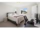 Comfortable bedroom with a cozy bed, a dedicated workspace, and ample natural light at 7856 W 43Rd Pl, Wheat Ridge, CO 80033