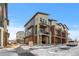 Townhome exteriors showcasing brick and siding, balconies, and snow-covered grounds at 7856 W 43Rd Pl, Wheat Ridge, CO 80033