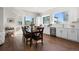 Open concept kitchen and dining area with hardwood floors and abundant natural light at 7856 W 43Rd Pl, Wheat Ridge, CO 80033