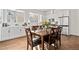 Well-lit eat-in kitchen featuring stainless steel appliances, modern cabinets, and hardwood floors at 7856 W 43Rd Pl, Wheat Ridge, CO 80033