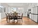Spacious eat-in kitchen featuring stainless steel appliances, modern cabinets, and hardwood floors at 7856 W 43Rd Pl, Wheat Ridge, CO 80033