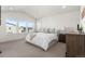 Serene primary bedroom featuring plush carpet, ample natural light from large windows, and neutral decor at 7856 W 43Rd Pl, Wheat Ridge, CO 80033