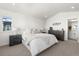 Spacious primary bedroom with soft carpet, two dressers, neutral decor, and ensuite access at 7856 W 43Rd Pl, Wheat Ridge, CO 80033
