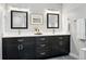 Double vanity bathroom featuring dark cabinetry and modern mirrors at 10320 W 35Th Ave, Wheat Ridge, CO 80033