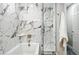 Stylish bathroom showcasing modern tile and a glass-enclosed shower over a soaking tub at 10320 W 35Th Ave, Wheat Ridge, CO 80033