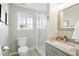 Fresh bathroom features a glass shower, white vanity, and window providing natural light at 10320 W 35Th Ave, Wheat Ridge, CO 80033