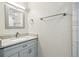 Modern bathroom vanity with a gray countertop, framed mirror, and chrome hardware and fixtures at 10320 W 35Th Ave, Wheat Ridge, CO 80033