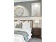 Bedroom featuring accent wall with stylish decor and bedside lighting at 10320 W 35Th Ave, Wheat Ridge, CO 80033