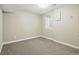 Neutral painted carpeted bedroom features a modern light fixture and a large window well for natural light at 10320 W 35Th Ave, Wheat Ridge, CO 80033