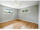 Bright bedroom features wood floors, neutral gray paint, and multiple windows for natural light at 10320 W 35Th Ave, Wheat Ridge, CO 80033