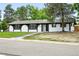 Charming single-story home featuring black and white paint scheme, landscaping, and front lawn at 10320 W 35Th Ave, Wheat Ridge, CO 80033