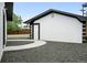 Detached garage with black and white exterior and new landscaping in the backyard at 10320 W 35Th Ave, Wheat Ridge, CO 80033