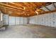 Spacious garage with a large door, exposed wood framing, and insulation, providing ample parking and storage space at 10320 W 35Th Ave, Wheat Ridge, CO 80033