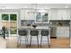 Stylish kitchen island with seating and modern fixtures with backyard view at 10320 W 35Th Ave, Wheat Ridge, CO 80033