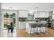 Modern kitchen with white cabinets, marble countertops, and stainless steel appliances at 10320 W 35Th Ave, Wheat Ridge, CO 80033