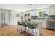 Bright, modern kitchen with white cabinets, island seating, and sliding door access to the backyard at 10320 W 35Th Ave, Wheat Ridge, CO 80033