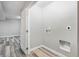 Bright laundry room featuring base trim, wood-look flooring, and washer/dryer hookups at 10320 W 35Th Ave, Wheat Ridge, CO 80033