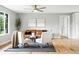 Comfortable living room featuring hardwood floors, a brown leather couch, and neutral decor at 10320 W 35Th Ave, Wheat Ridge, CO 80033