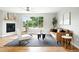 Bright living room with hardwood floors, fireplace, and a large window overlooking the yard at 10320 W 35Th Ave, Wheat Ridge, CO 80033