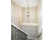 Hallway staircase with hanging pendant light, white walls and black iron handrail at 10320 W 35Th Ave, Wheat Ridge, CO 80033