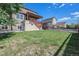 Large backyard featuring a well-maintained lawn, a patio, and surrounding neighborhood homes at 6147 N Flanders St, Aurora, CO 80019