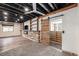 Basement showcasing rustic door, modern fireplace, and ample custom shelving at 6147 N Flanders St, Aurora, CO 80019