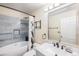 Well-lit bathroom featuring a modern vanity, elegant bathtub, and stylish tilework at 6147 N Flanders St, Aurora, CO 80019