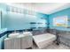 Bright turquoise bathroom with double vanity, soaking tub, stylish fixtures, and ample lighting at 6147 N Flanders St, Aurora, CO 80019