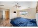 Bright bedroom featuring a ceiling fan, large window with neighborhood views, and en-suite access at 6147 N Flanders St, Aurora, CO 80019