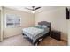 Comfortable bedroom featuring a ceiling fan, window with pleasant neighborhood views, and closet at 6147 N Flanders St, Aurora, CO 80019