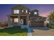 Charming two-story home featuring stone accents, a covered porch, and a two-car garage at 6147 N Flanders St, Aurora, CO 80019