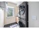 A convenient laundry area with a stacked washer and dryer unit and ample storage space at 6147 N Flanders St, Aurora, CO 80019