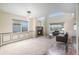 Bright living room featuring a fireplace, large windows, and comfortable seating area at 6147 N Flanders St, Aurora, CO 80019