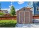 Backyard shed offers ample storage with a fenced-in yard and blue skies at 6147 N Flanders St, Aurora, CO 80019