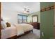 Cozy bedroom with a ceiling fan, dresser, and a window view at 16234 E Belleview Dr, Centennial, CO 80015