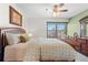 Comfortable bedroom featuring a ceiling fan, a dresser, and a window seat at 16234 E Belleview Dr, Centennial, CO 80015