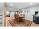 Basement dining area featuring a decorative rug, a game machine and six wooden chairs at the dining table at 16234 E Belleview Dr, Centennial, CO 80015