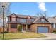 Charming two-story home with brick and siding and a well-manicured front yard at 16234 E Belleview Dr, Centennial, CO 80015